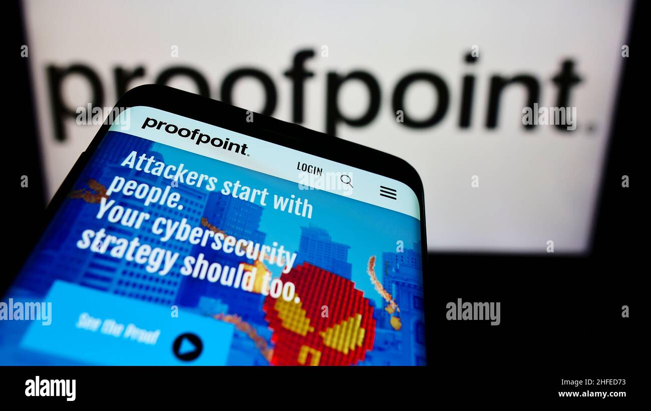 Mobile phone with website of US security software company Proofpoint Inc. on screen in front of business logo. Focus on top-left of phone display. Stock Photo