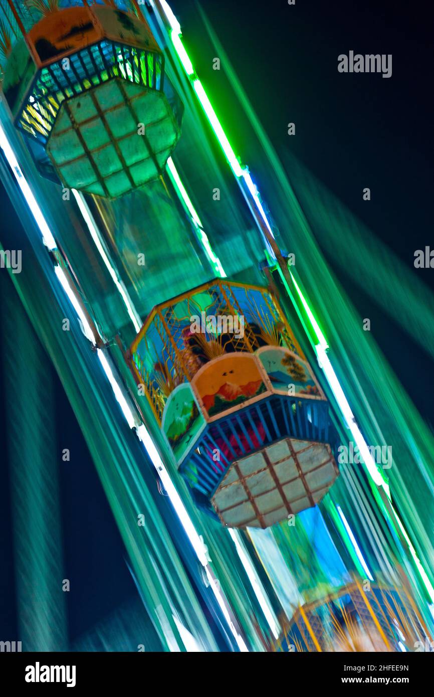 people enjoy the big wheel in the amusement park in Delhi in front of the red fort Stock Photo