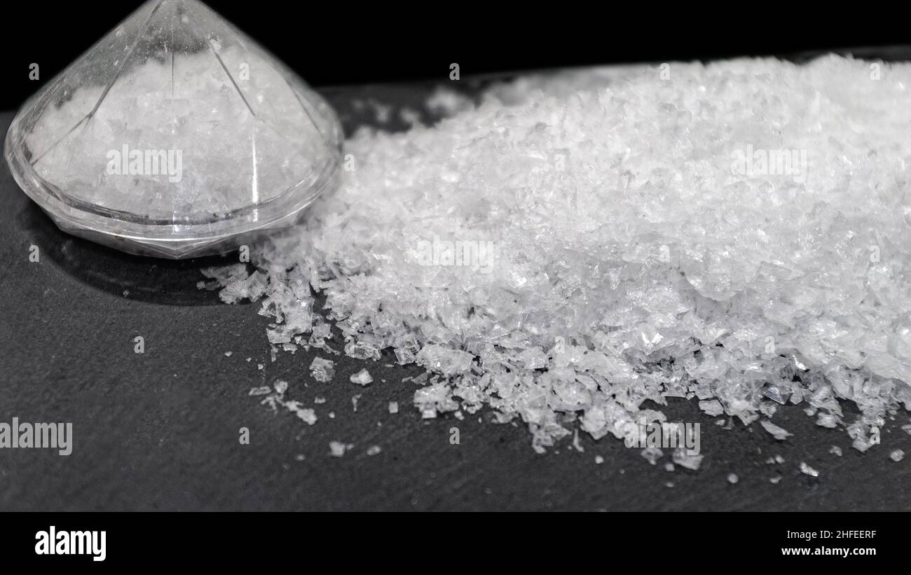 Coarse salt on black slate with transparent salt shaker Stock Photo Alamy