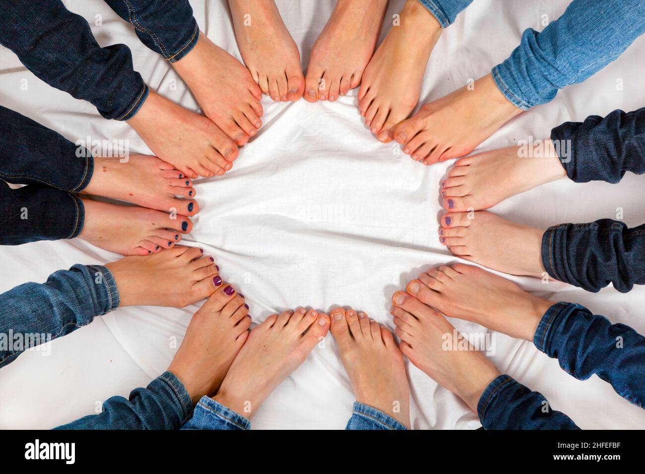 feet of girls form a circle Stock Photo - Alamy