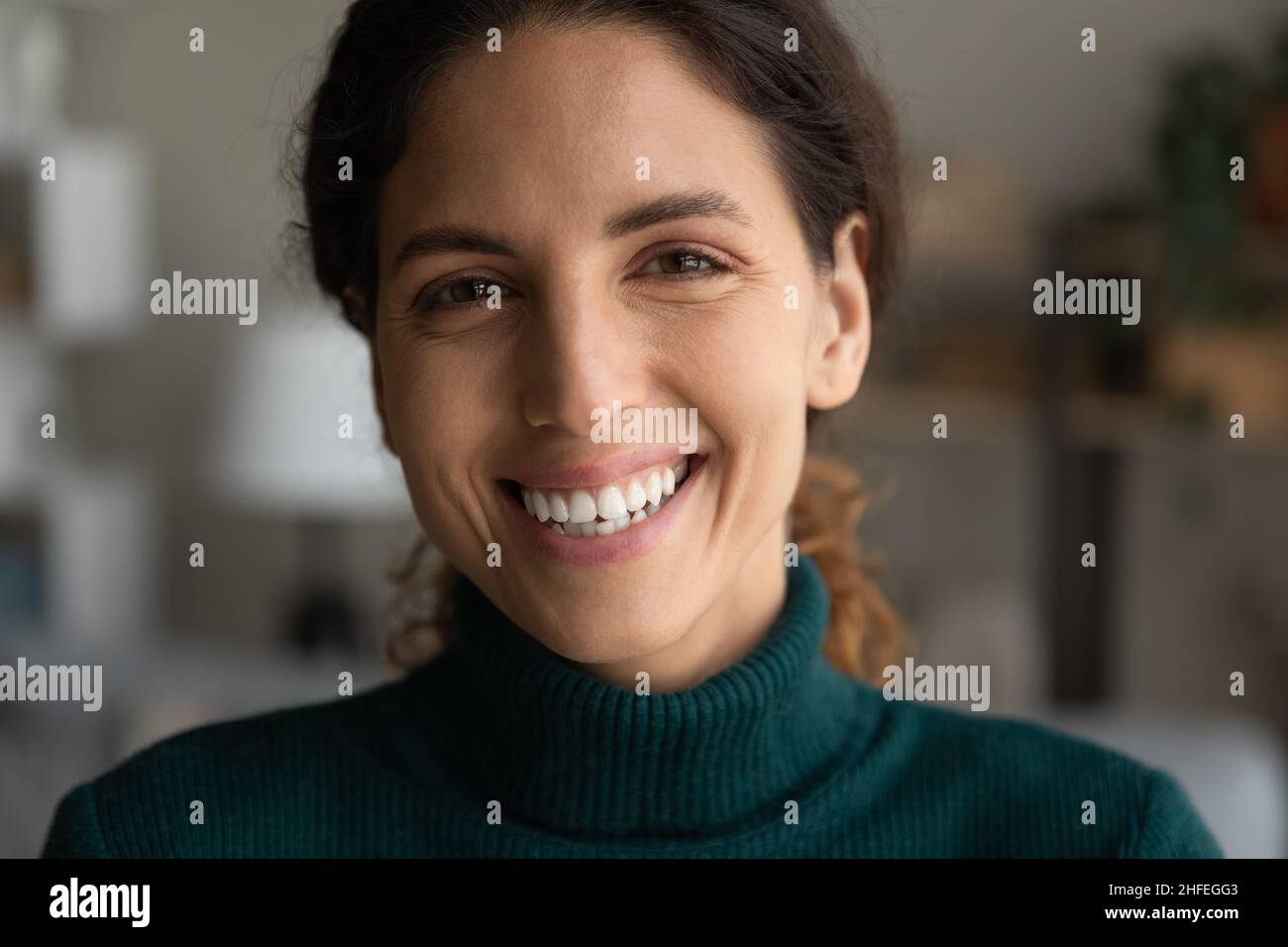 Happy millennial generation woman looking at camera. Stock Photo