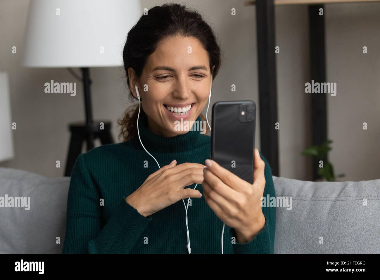 Happy young woman holding mobile video call conversation Stock Photo ...