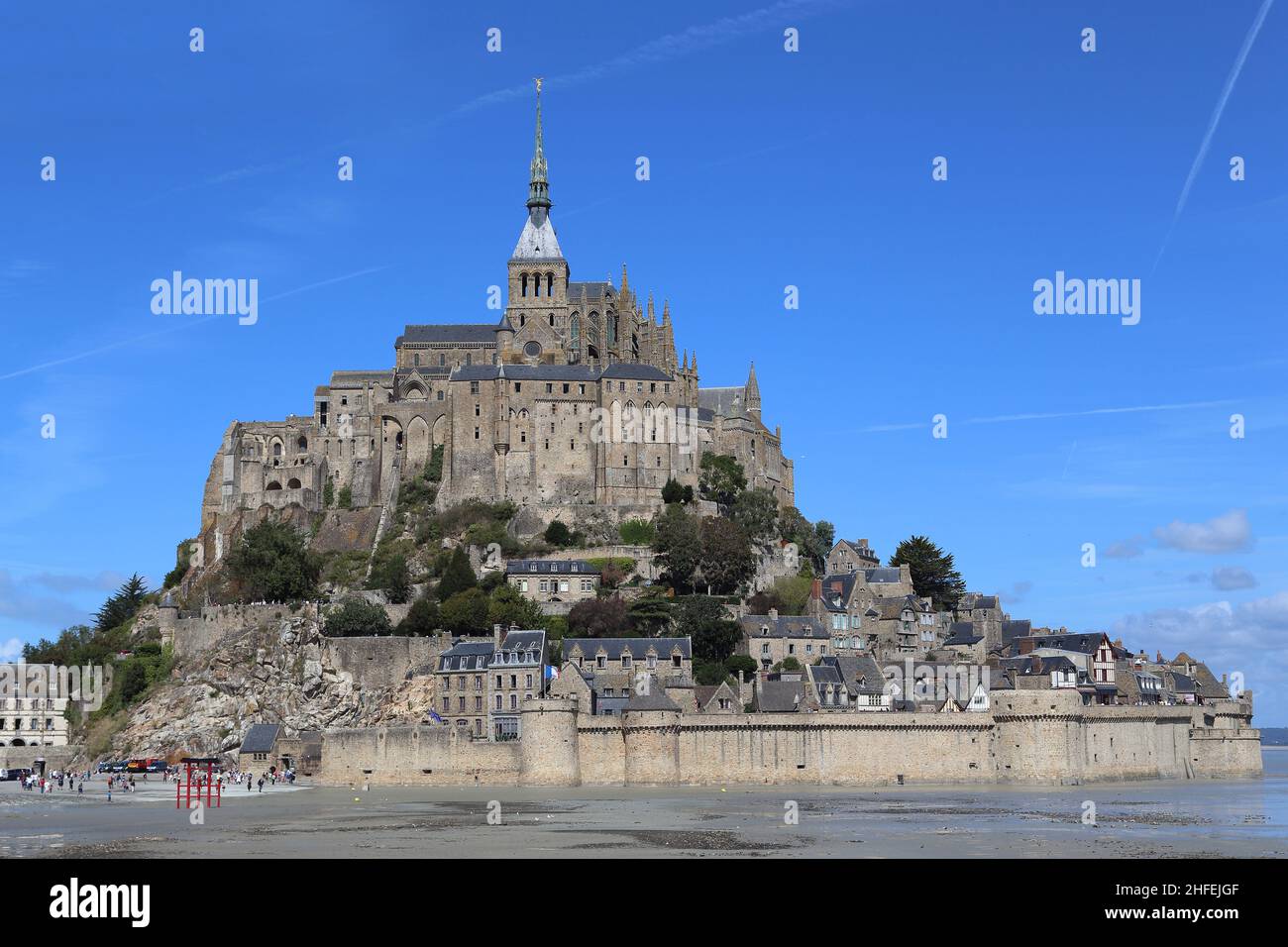 MONT SAINT-MICHEL, FRANCE - SEPTEMBER 2, 2019: It is a small fortified rocky island with a medieval abbey on top, which becomes part of the land at lo Stock Photo