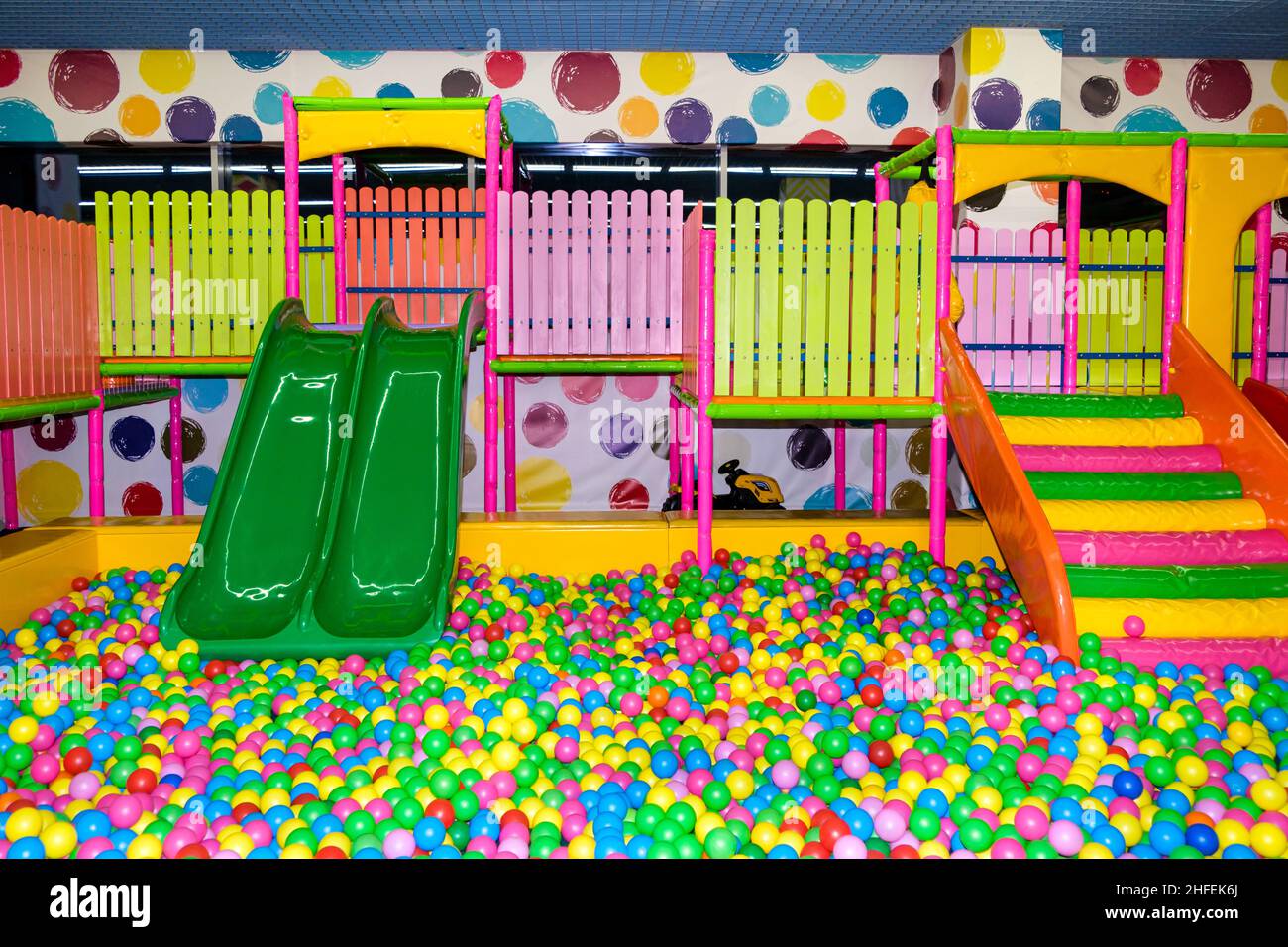 Slides and pool with balls in the playroom, children's entertainment