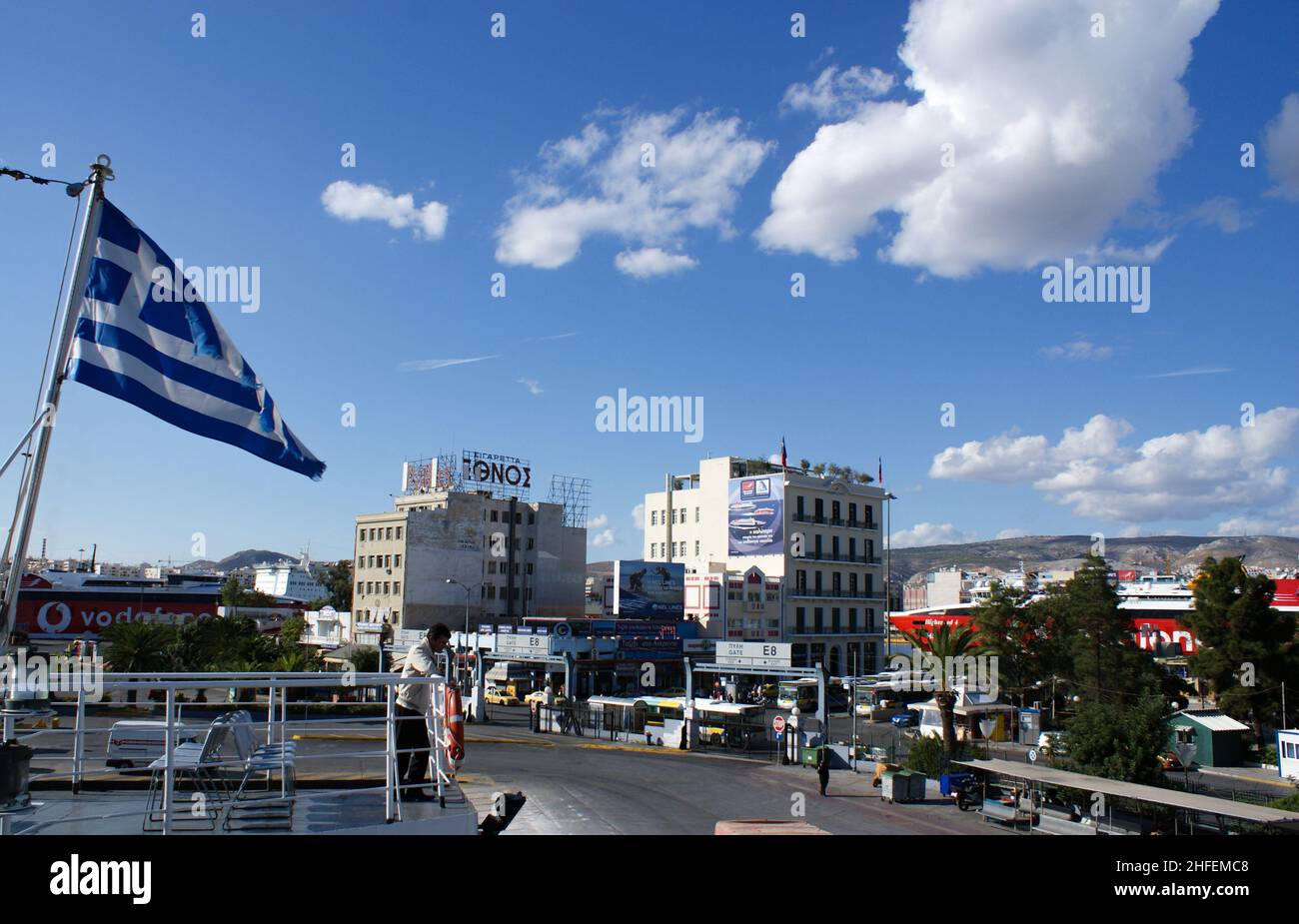 Piraeus - Greece - October 14 2010 : Landscape of the port of Athens with view of the harbor anmd with the Greek national flag.  Blue sky and copy spa Stock Photo