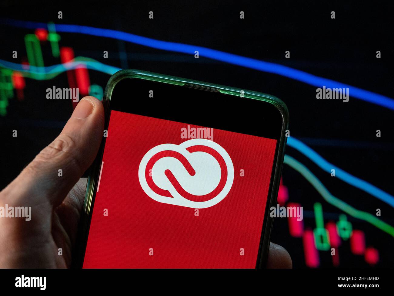 China. 09th Dec, 2021. In this photo illustration the file hosting service and computer software access owned by Adobe Systems, Adobe Creative Cloud, logo seen displayed on a smartphone with an economic stock exchange index graph in the background. Credit: SOPA Images Limited/Alamy Live News Stock Photo