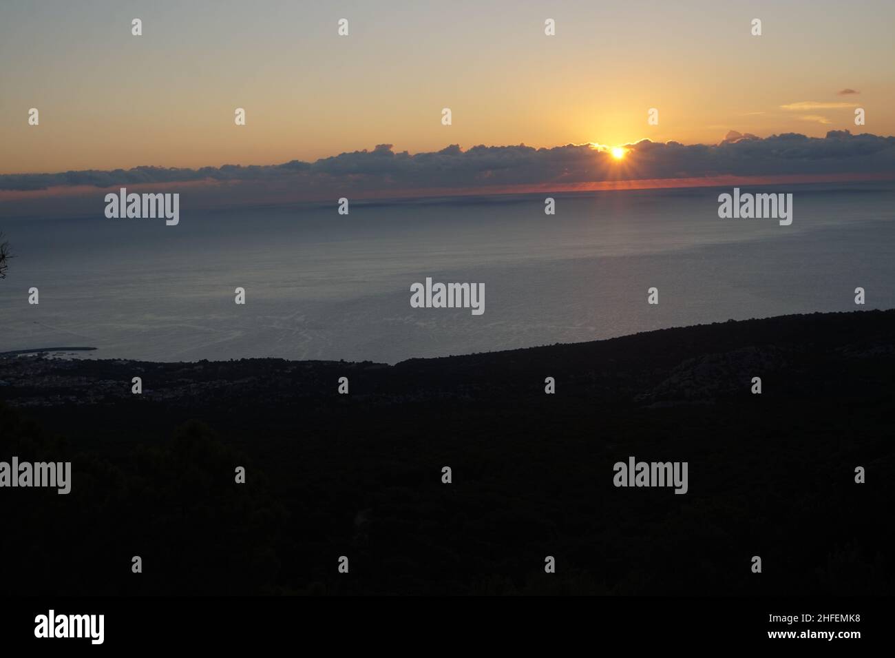 Sunrise above the ocean and Cala Gonone Stock Photo