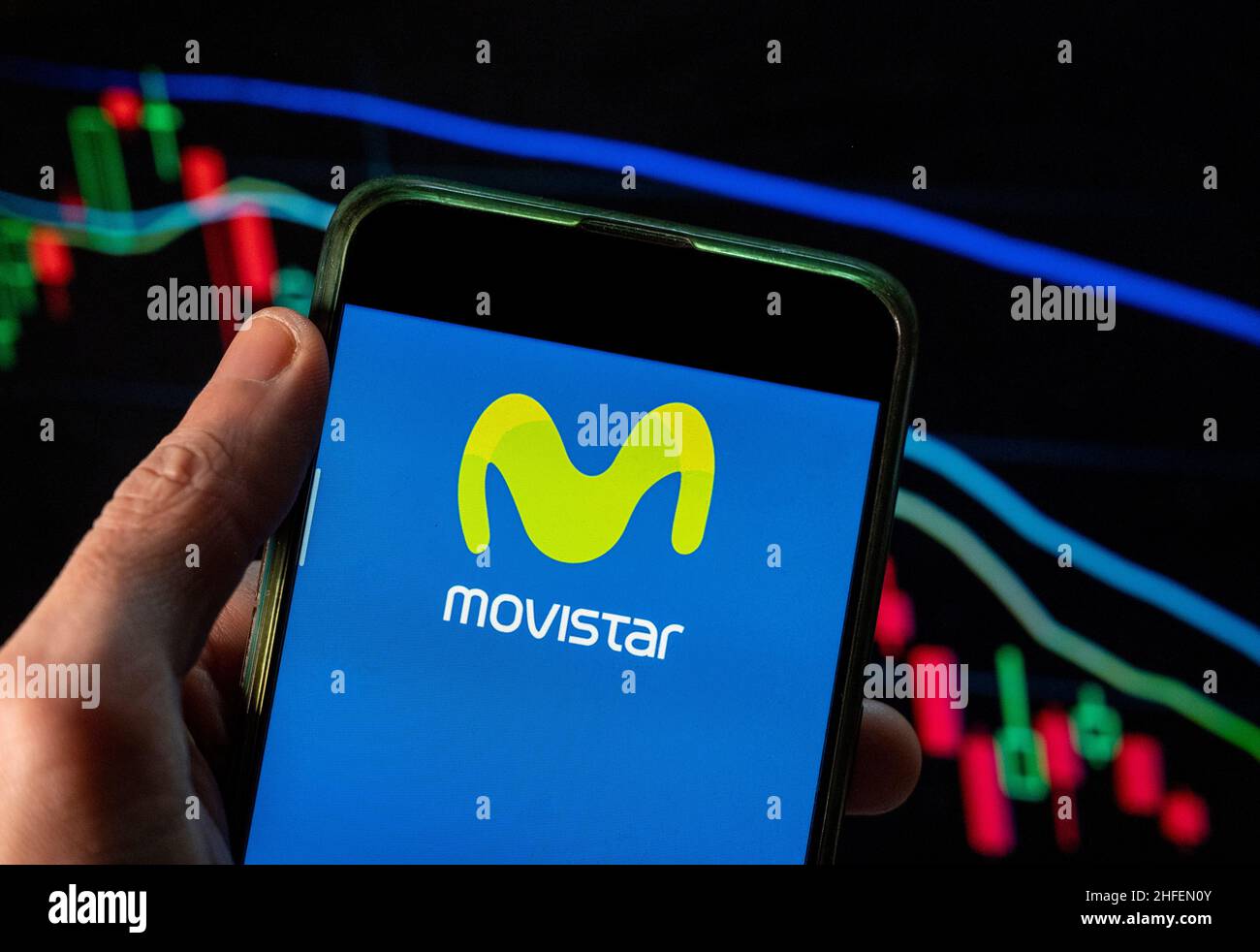 In this photo illustration the Spanish telecommunications brand owned by Telefonica and largest mobile phone operator, Movistar, logo seen displayed on a smartphone with an economic stock exchange index graph in the background. (Photo by Budrul Chukrut / SOPA Images/Sipa USA) Stock Photo