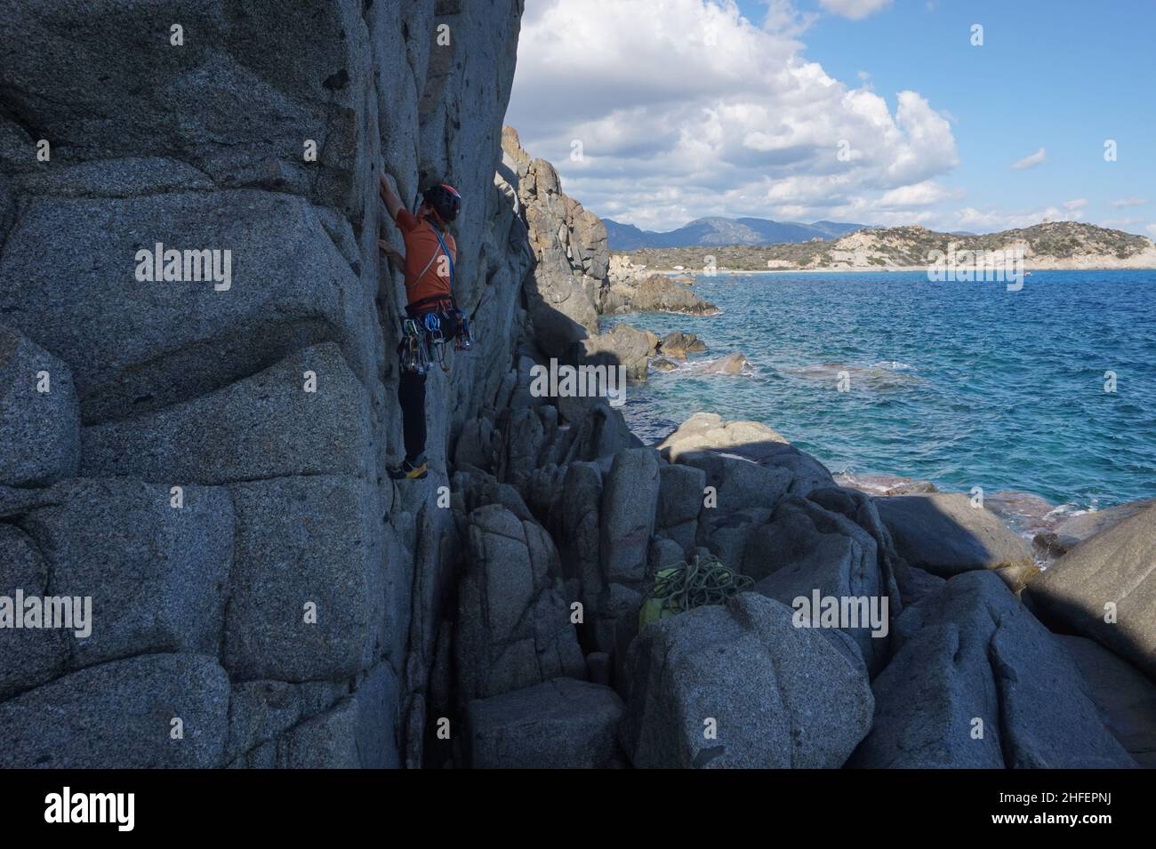 Climbing above the sea in the south of Sardinia on perfect granite Stock Photo