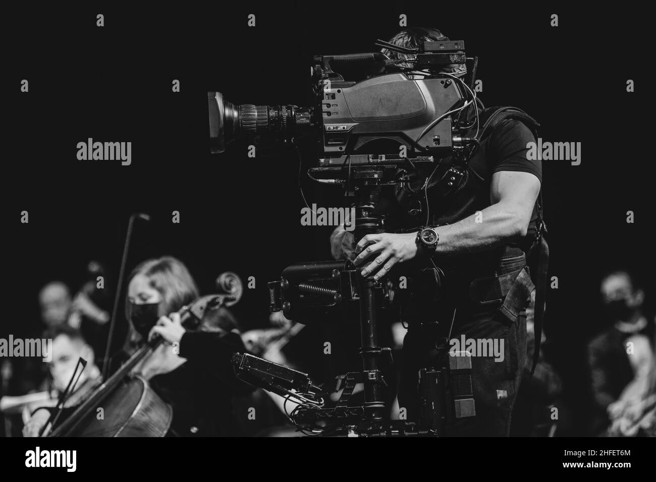 Bucharest, Romania - January 15, 2022: Professional steadicam (gimbal) operator filming a classical music concert. Stock Photo