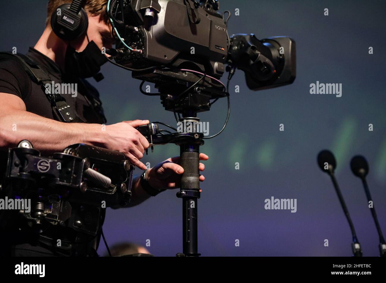 Bucharest, Romania - January 15, 2022: Professional steadicam (gimbal) operator filming a classical music concert. Stock Photo