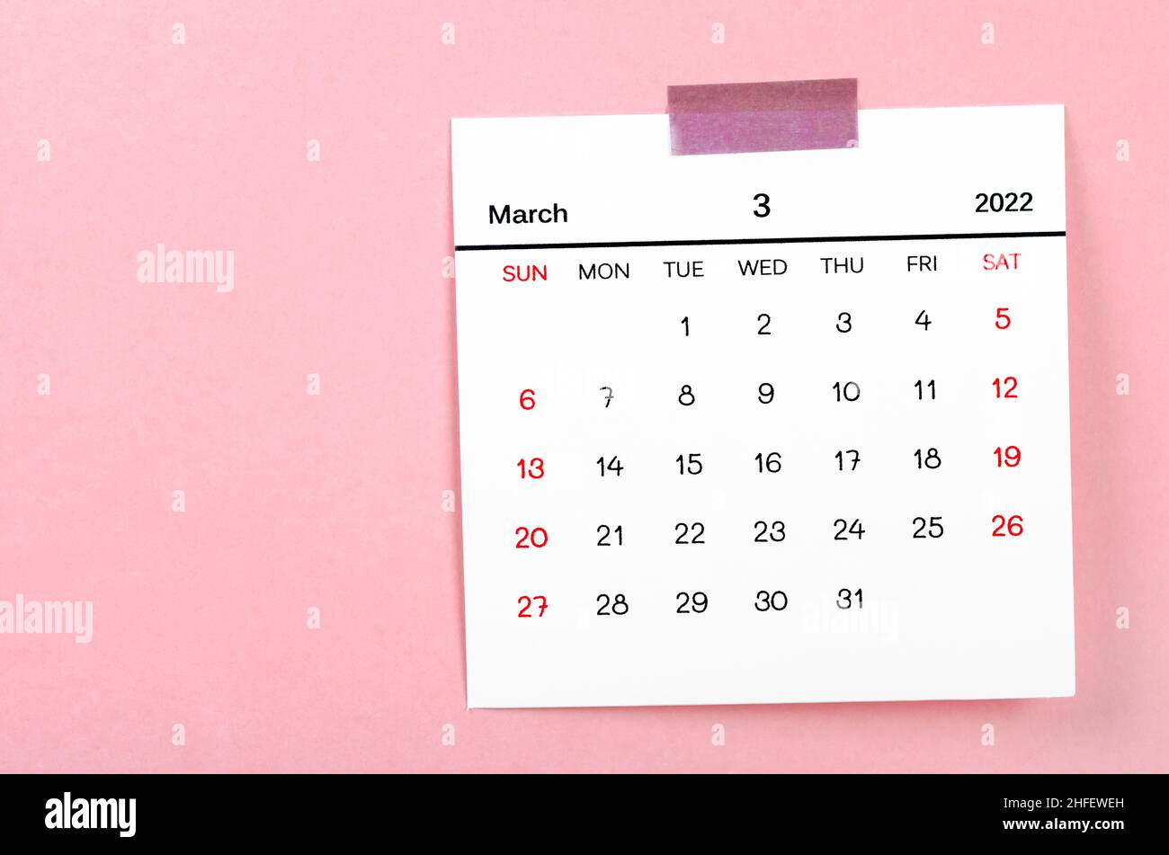 The March 2022 calendar on pink background. Stock Photo