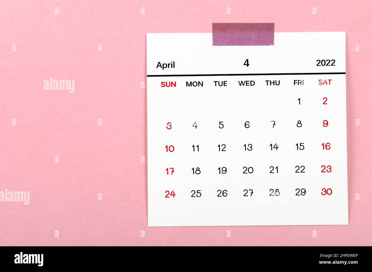 The April 2022 calendar on pink background. Stock Photo