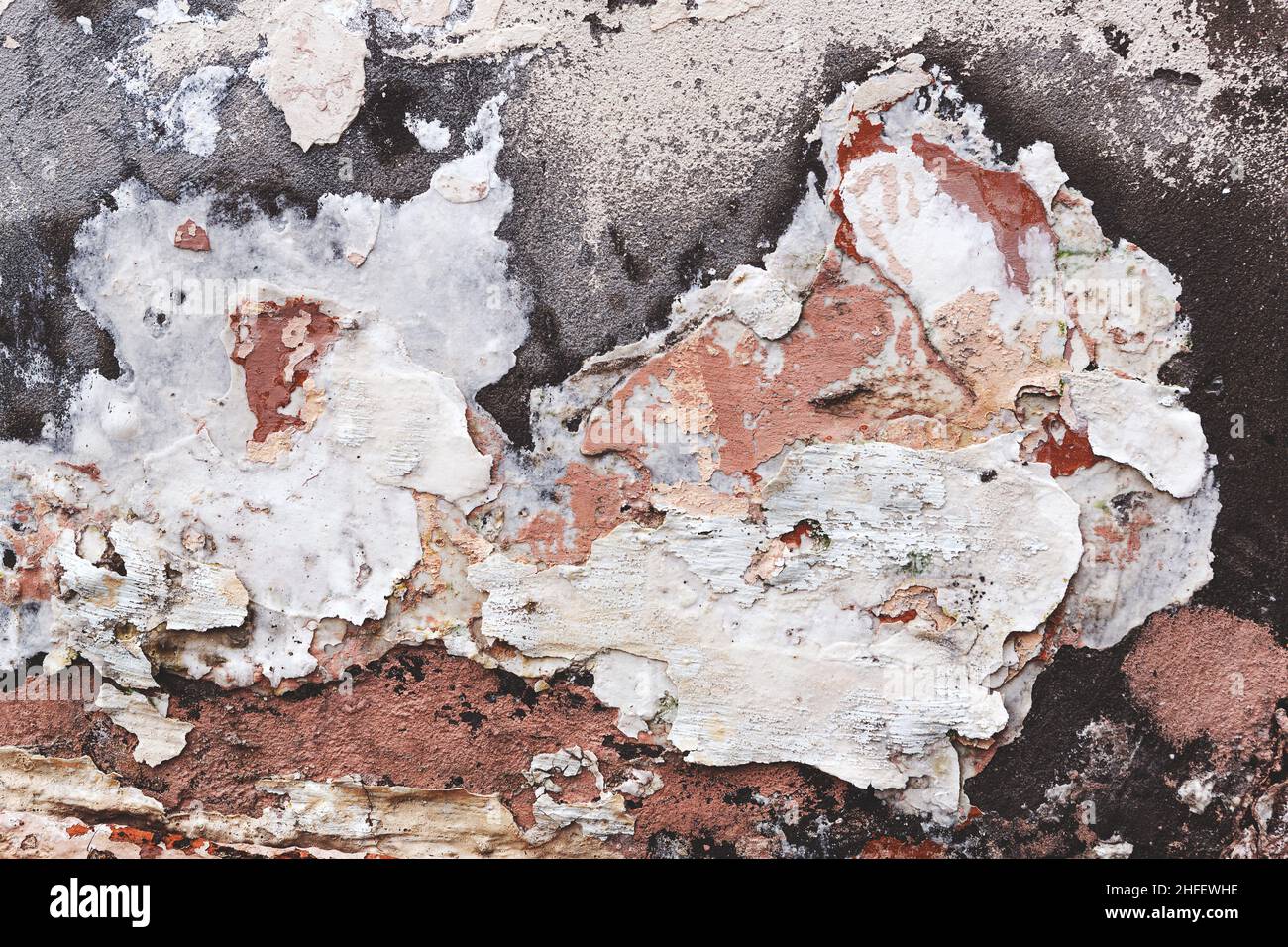 Concrete, weathered, worn, damaged wall paint. Rough, concrete surface with cracks and scratches. Great background or texture. Stock Photo