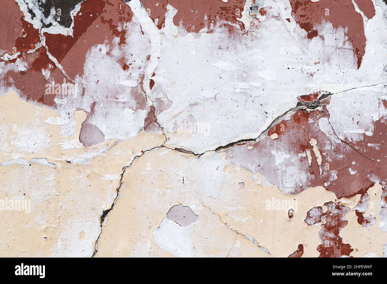 Concrete, weathered, worn, damaged wall paint. Rough, concrete surface with cracks and scratches. Great background or texture. Stock Photo
