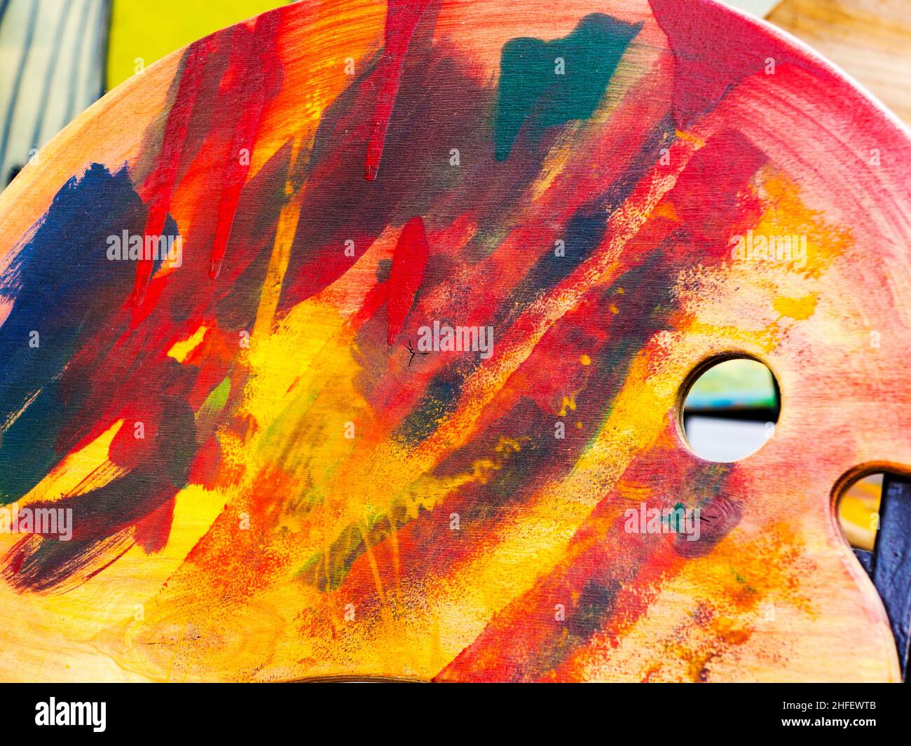 Artist palette with different colors isolated on a wooden surface. Selective focus Stock Photo