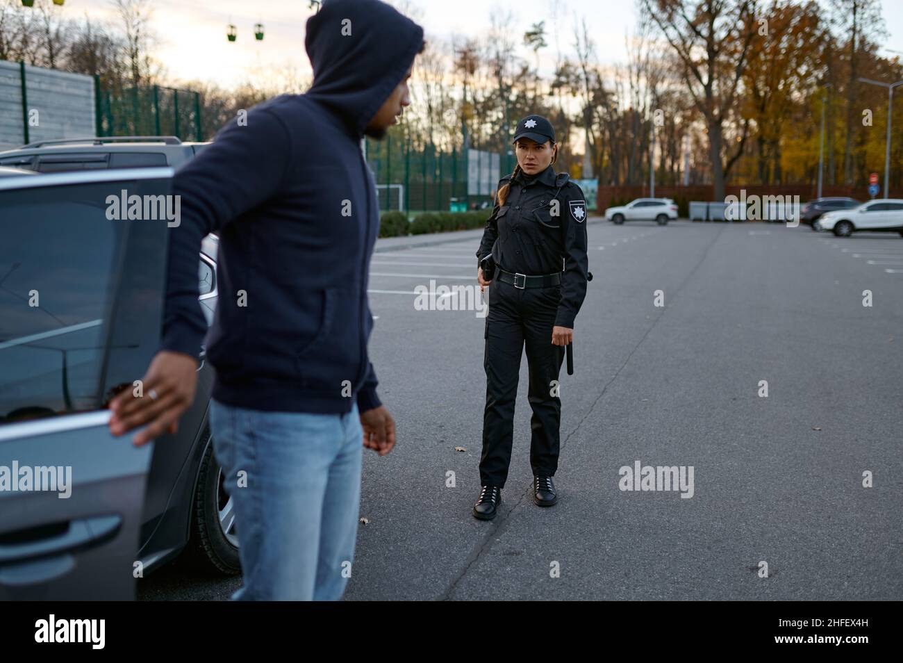 Police officer trying talk with car thief Stock Photo - Alamy