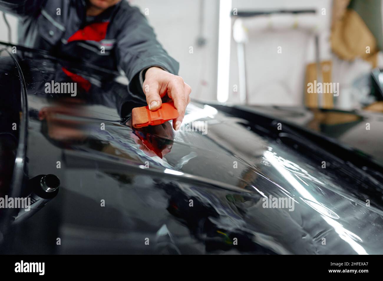 Auto service worker coating luxury black car Stock Photo Alamy