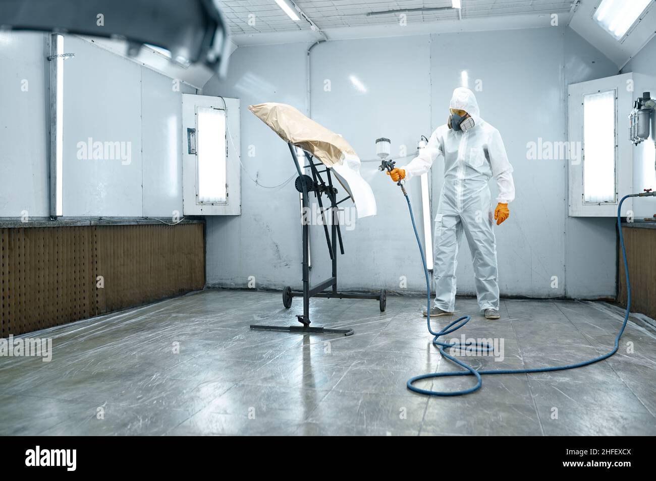 Repairman with airbrush pulverizer painting car door Stock Photo - Alamy
