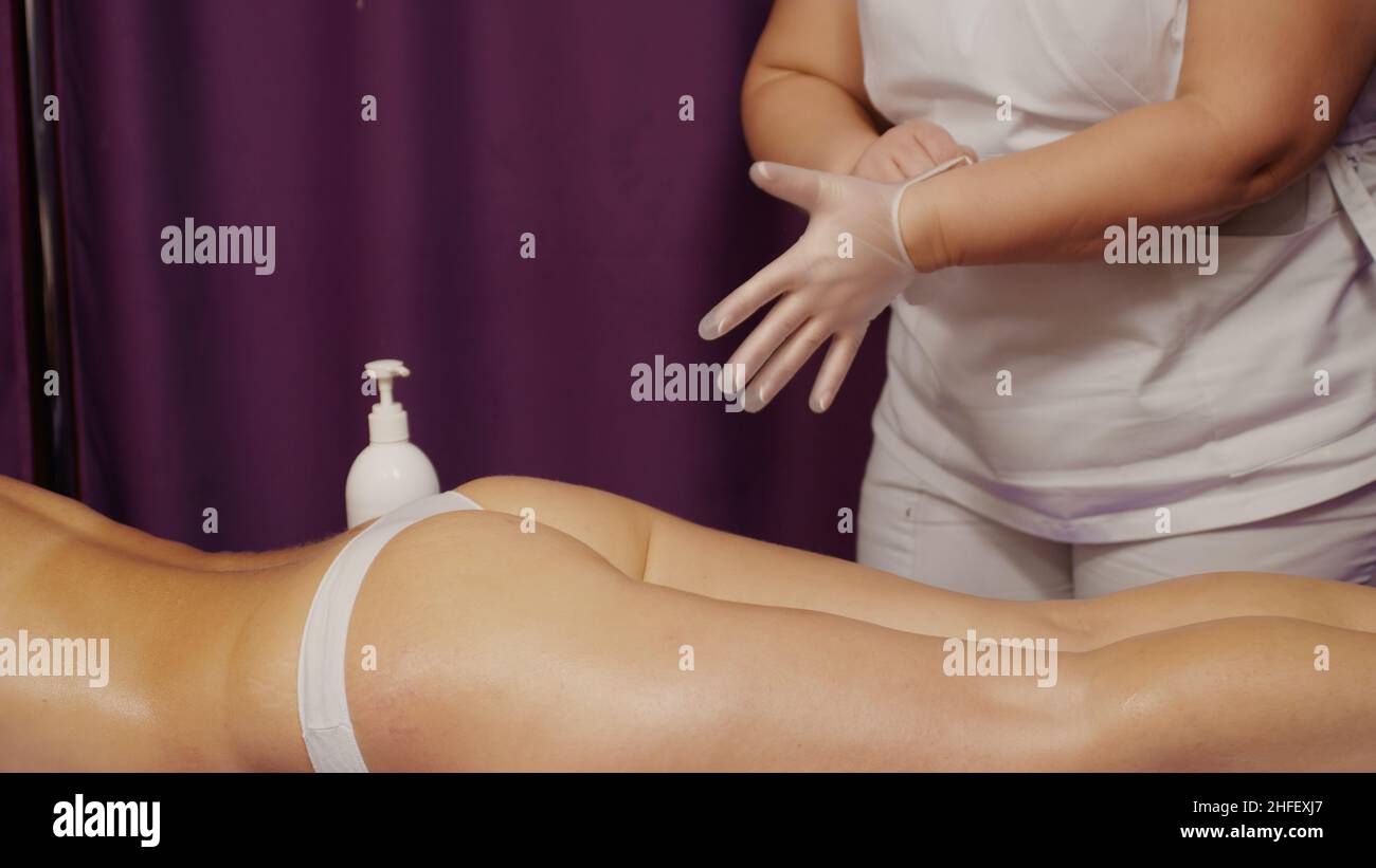 Vacuum massage apparatus. Vacuum massage of buttocks and legs. Anti- cellulite body shaping procedure. Slimming machine. Young woman and doctor  in medicine salon Stock Photo - Alamy