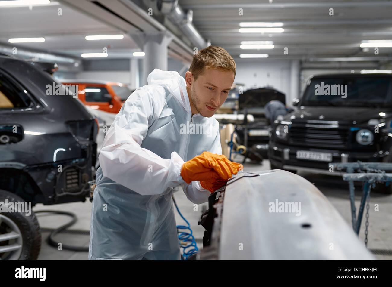 Mechanic engaged in local repairing car body Stock Photo