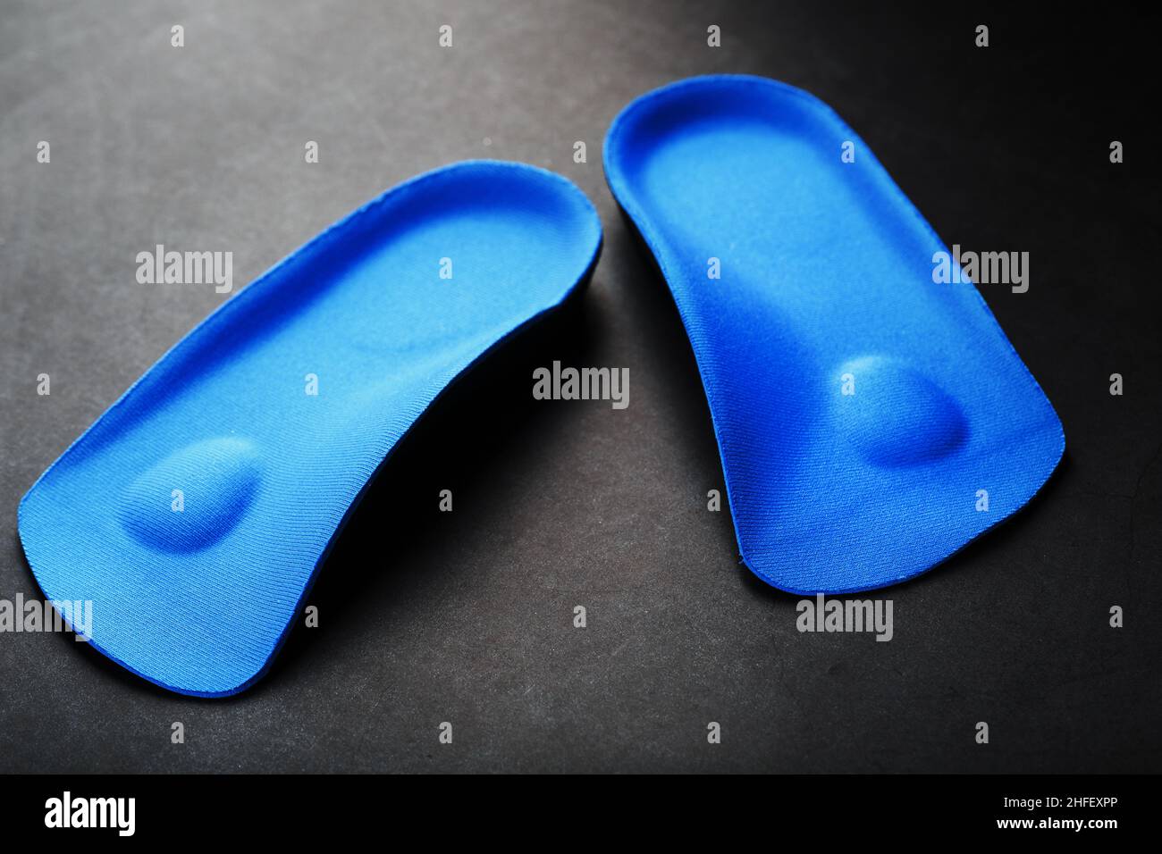 Orthopedic insoles for correction of pronation of the foot on a dark