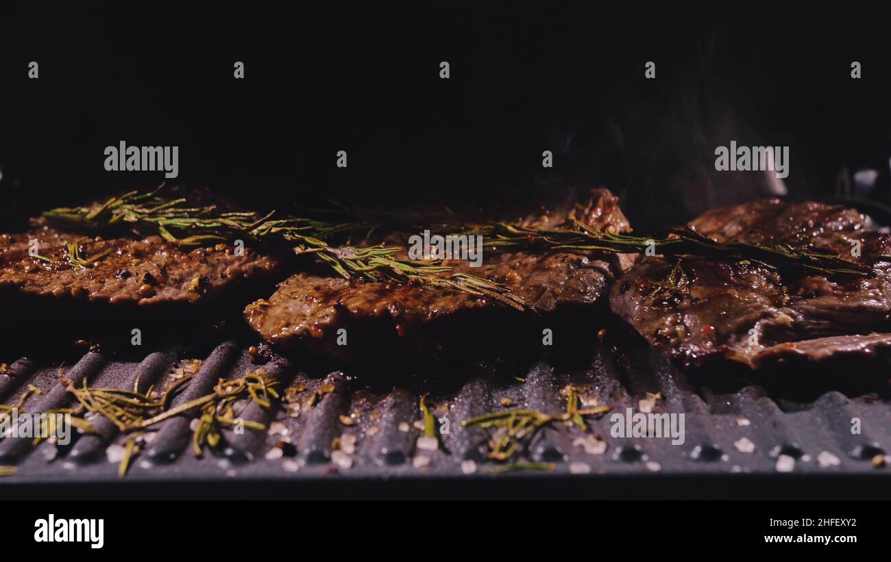 Delicious juicy meat steak cooking on grill. Aged prime rare roast