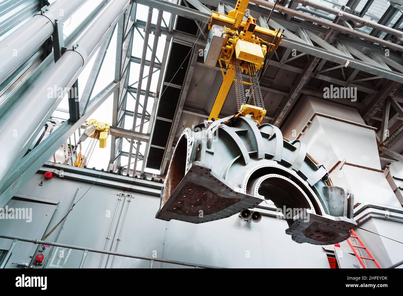 Part of the turbine compressor housing is suspended on a crane. Repair of gas turbines Stock