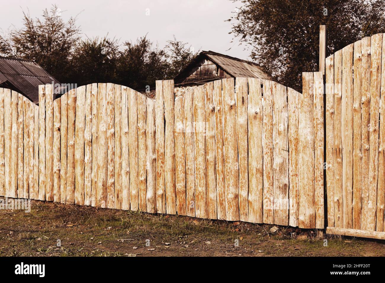 Rural landscape with a wooden fence around the old house Stock Photo ...