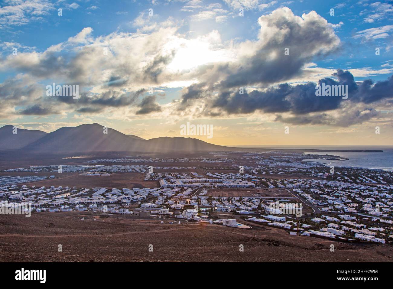 view over Playa Blanca in morning light with mountains Stock Photo