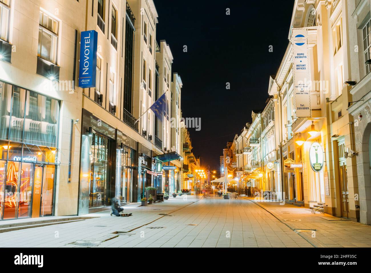 Vilnius Lithuania. View Of Vilniaus Street In Night Under Summer Black Sky. Illuminated Architecture Stock Photo