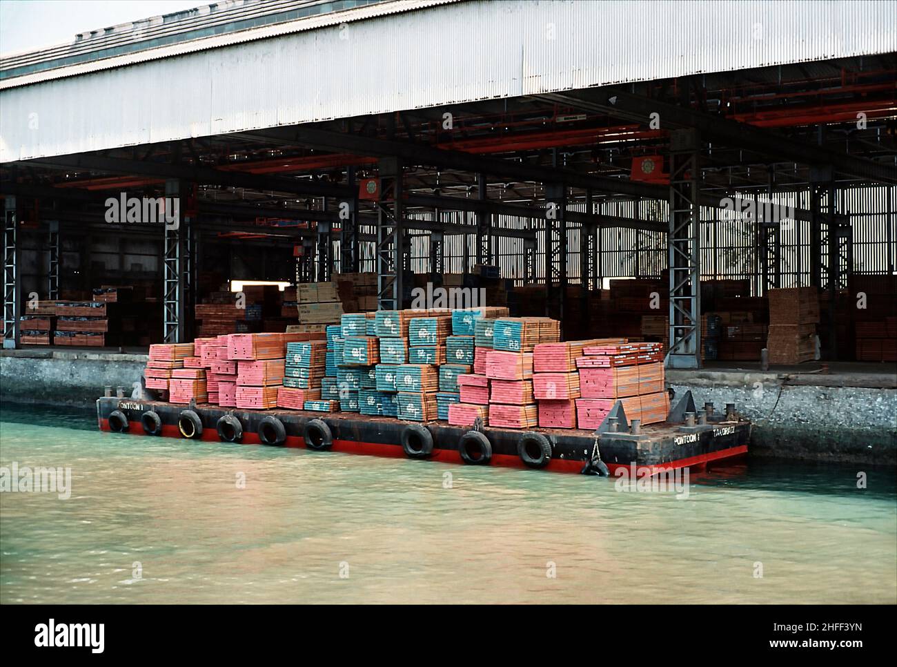 Barge loaded with timber at the timber terminal in Takoradi, Ghana, West Africa. Stock Photo