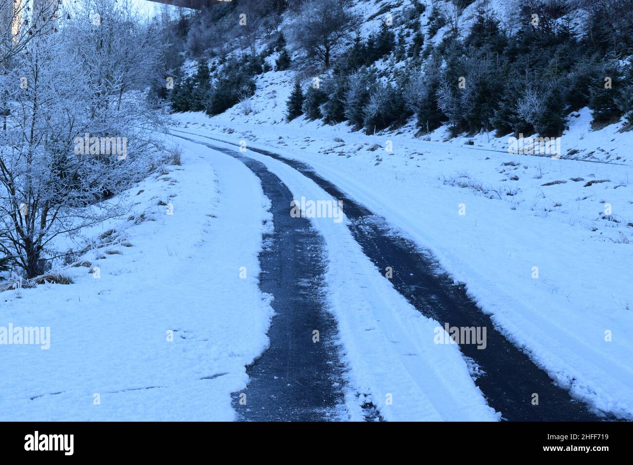 tire tracks in snow on a rural road Stock Photo - Alamy