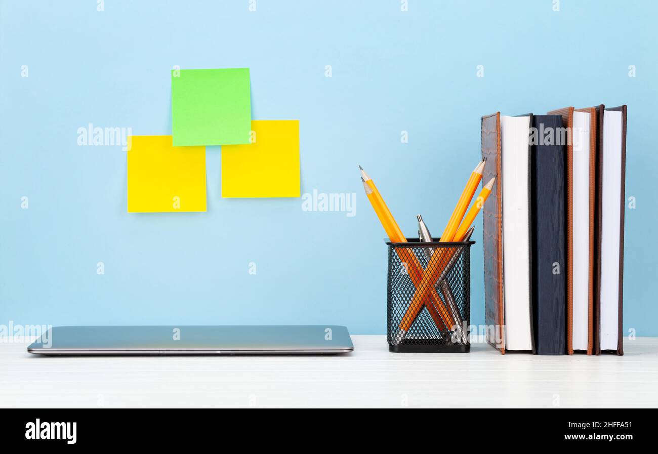 Studio workspace with laptop computer and office supplies. Work from