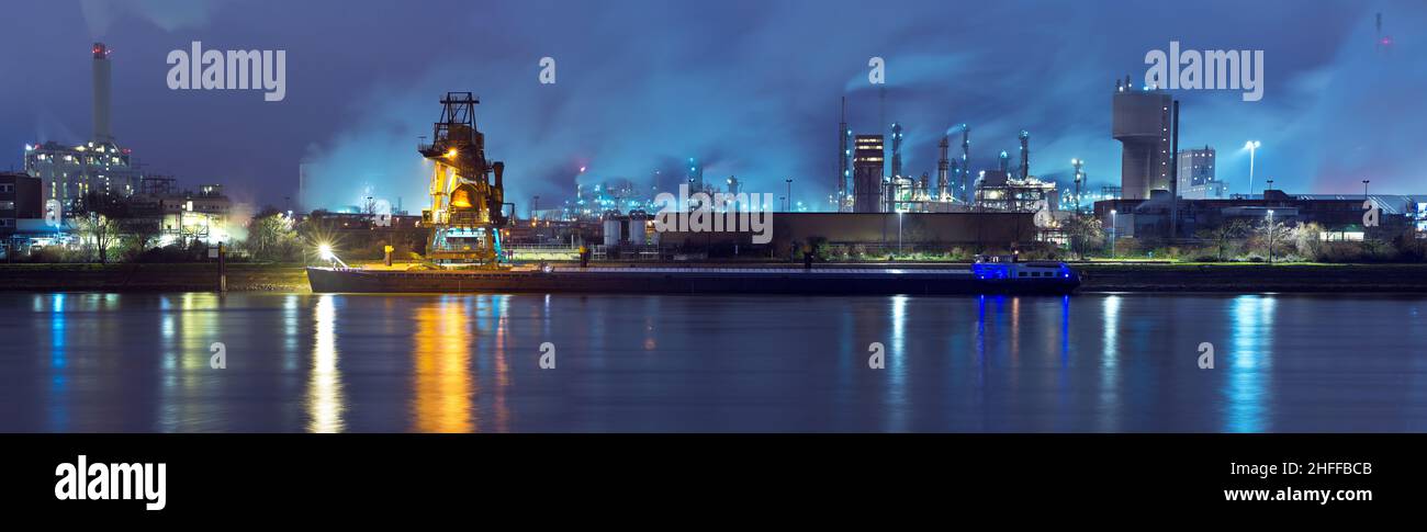 Night view of a chemical industry plant with dock in the foreground Stock Photo