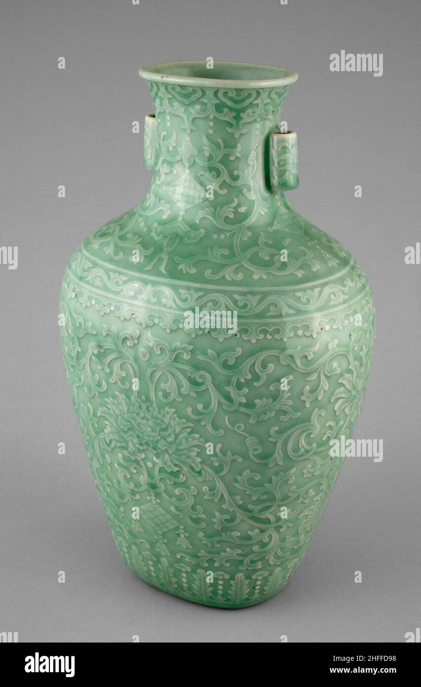 Jar with Tubular Handles, Peonies, 'Endless Knot,' Pendant Balls, and Pendant Lozenges, Qing dynasty (1644-1911), Qianlong reign mark and period (1736-1795). Green glazed vessel decorated with floral adornments, tapered and flared at the neck, with two small cylindrical handles. Stock Photo