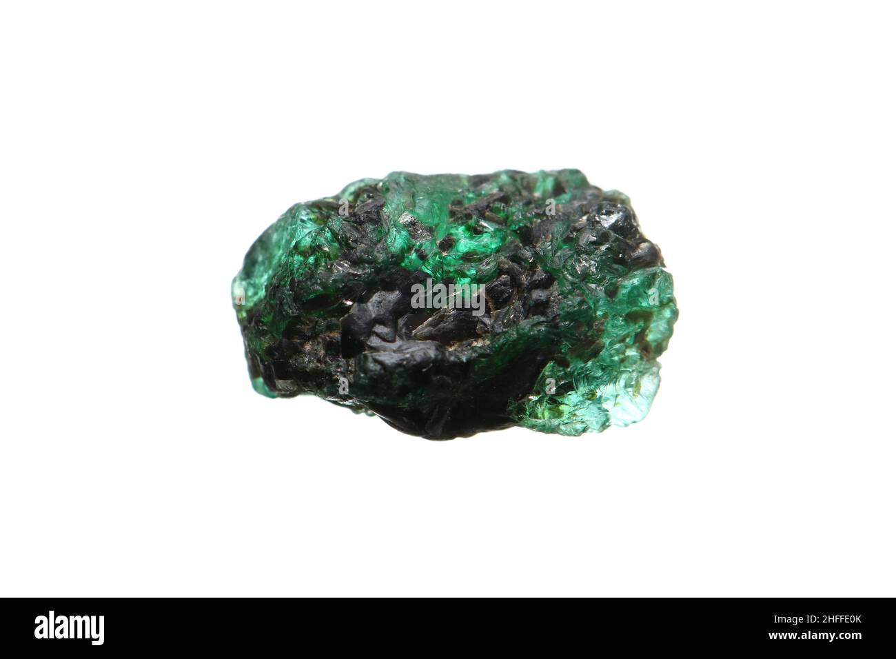 Closeup natural rough emerald (green beryl) gemstone on biotite matrix Stock Photo