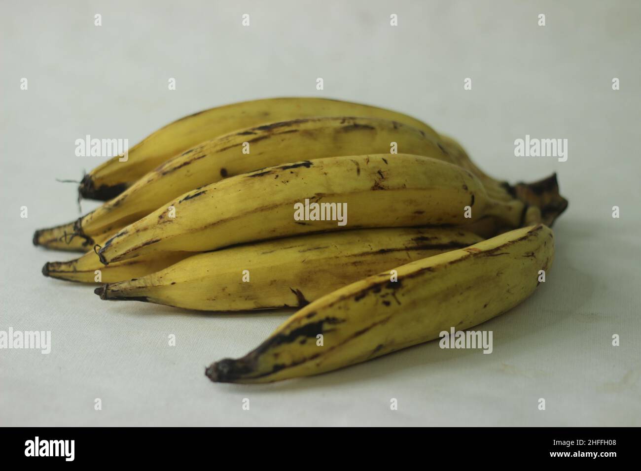 Ripe plantain yellow in colour and thin round plantain slices, ready to eat. Ethakka or plantain is a major banana variety called genus musa that are Stock Photo
