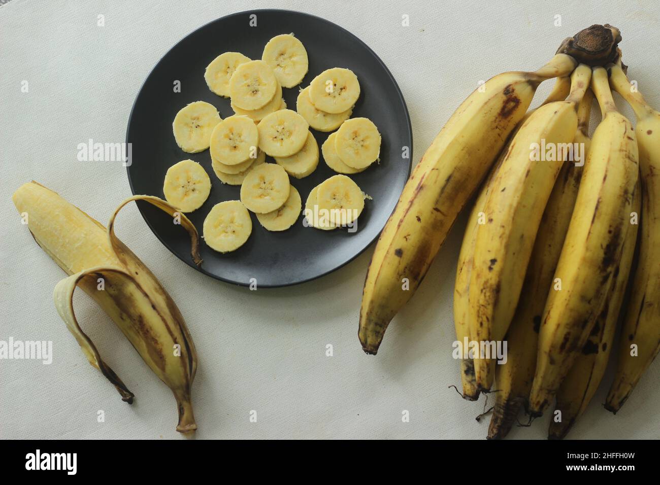 Ripe plantain yellow in colour and thin round plantain slices, ready to eat. Ethakka or plantain is a major banana variety called genus musa that are Stock Photo