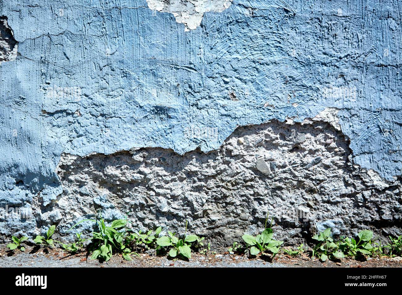 Large Section of Blue Wall Crumbled Away Stock Photo