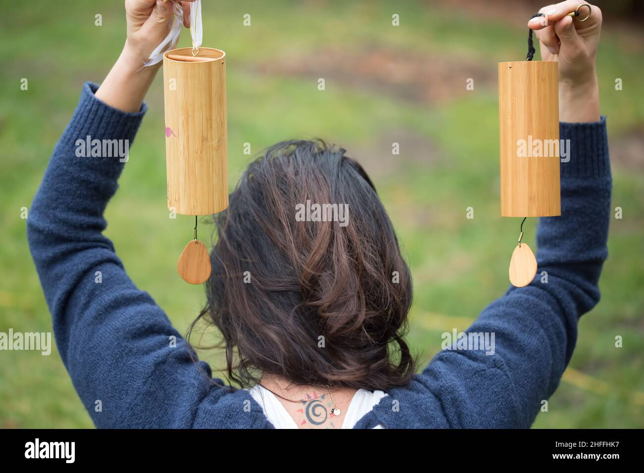 Girl holding Tibetan bells outdoors, sound therapy Stock Photo Alamy
