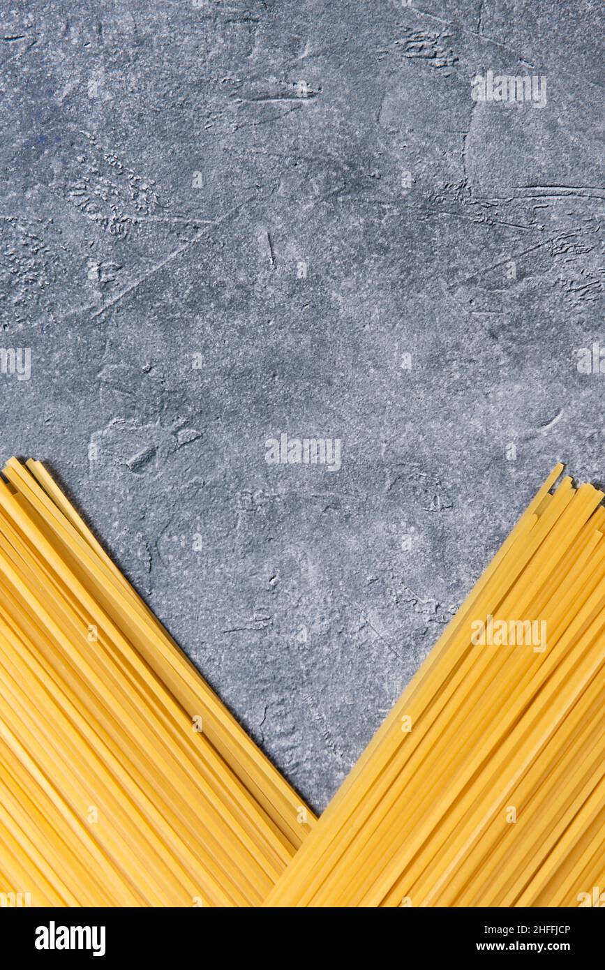 View from above of linguine pasta on stone background. Stock Photo