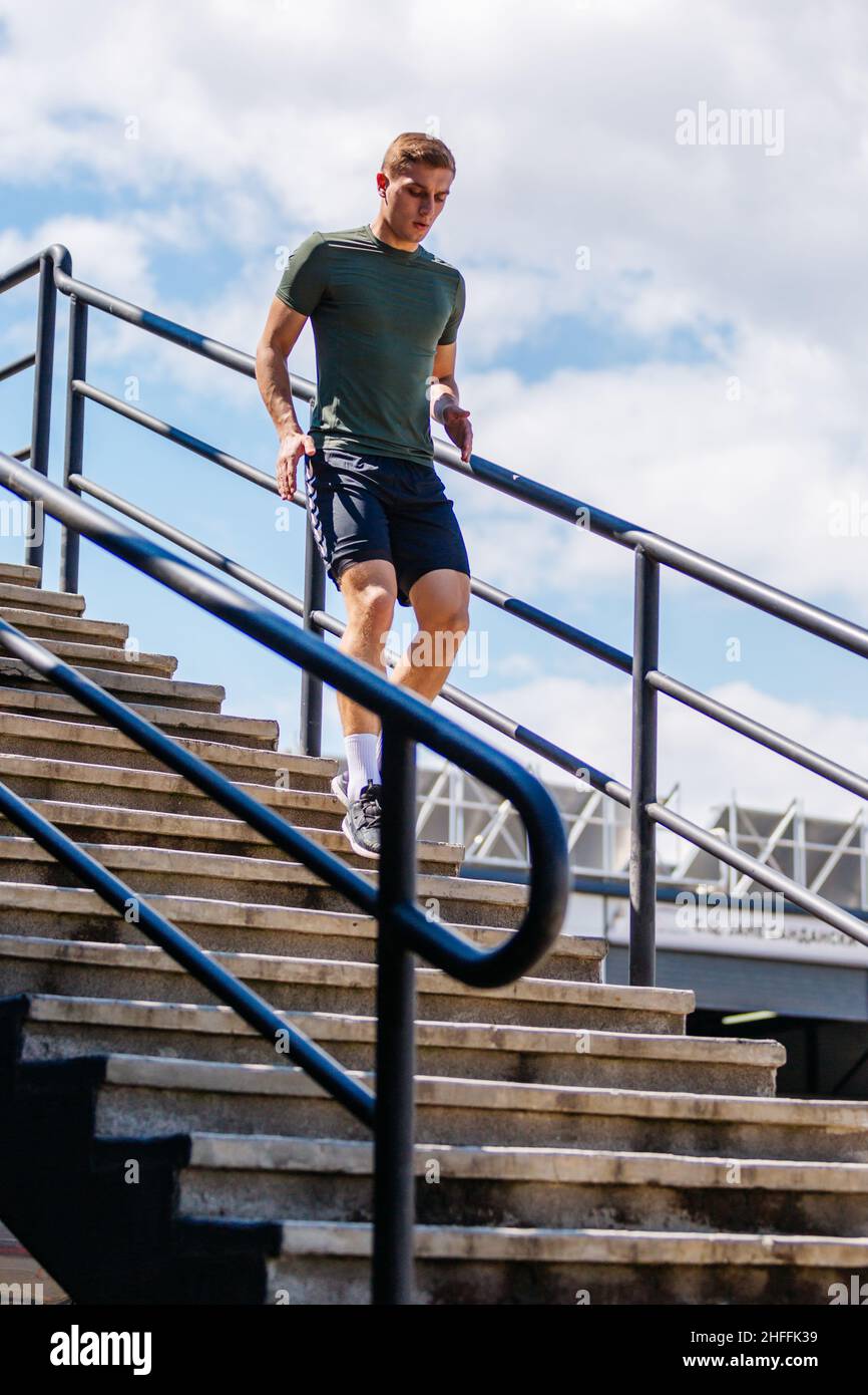 Sport man running. Portrait of runner man jogging in park. Sport