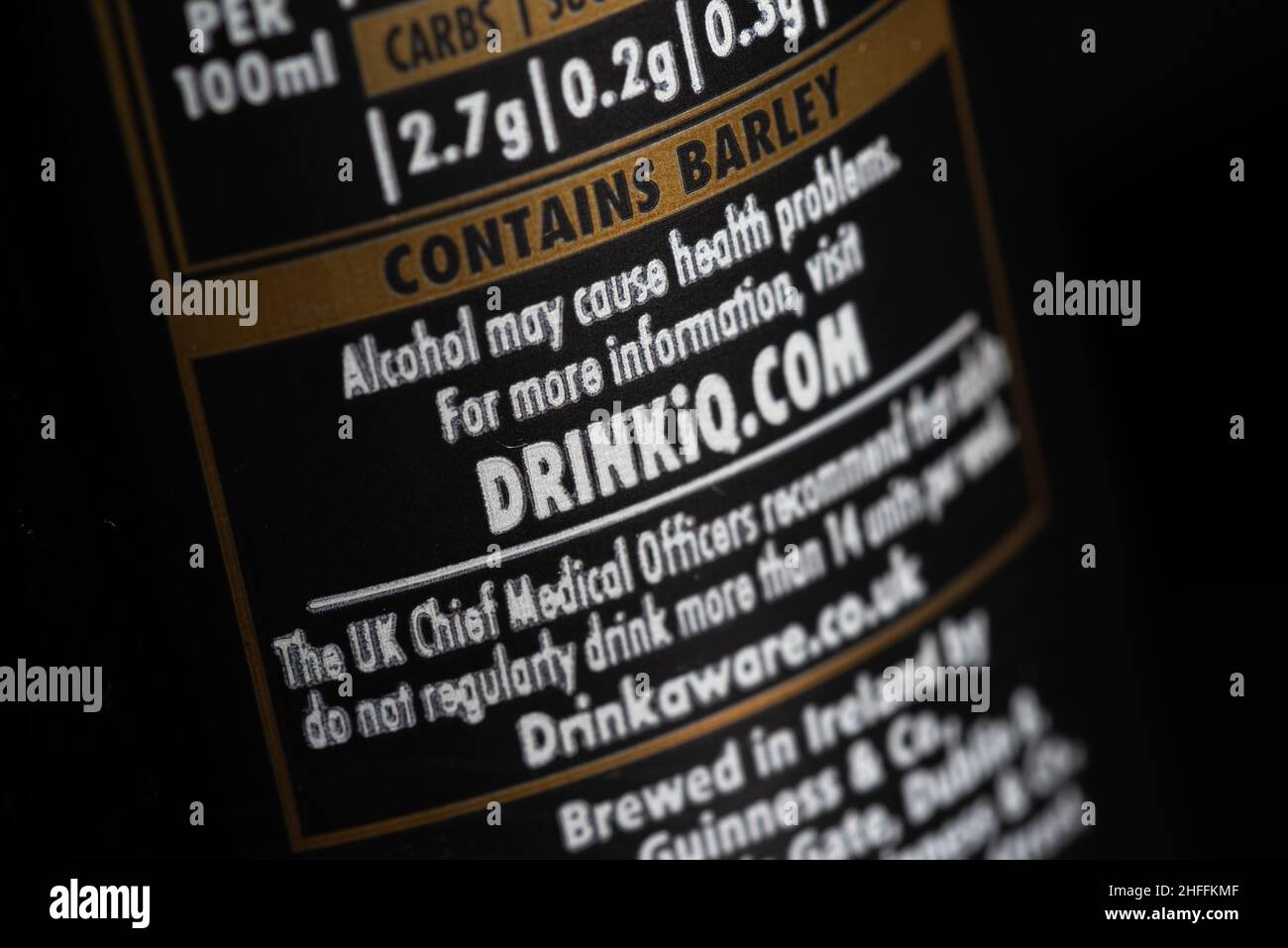 Back label information on Guinness draught stout can close up detail on black Stock Photo
