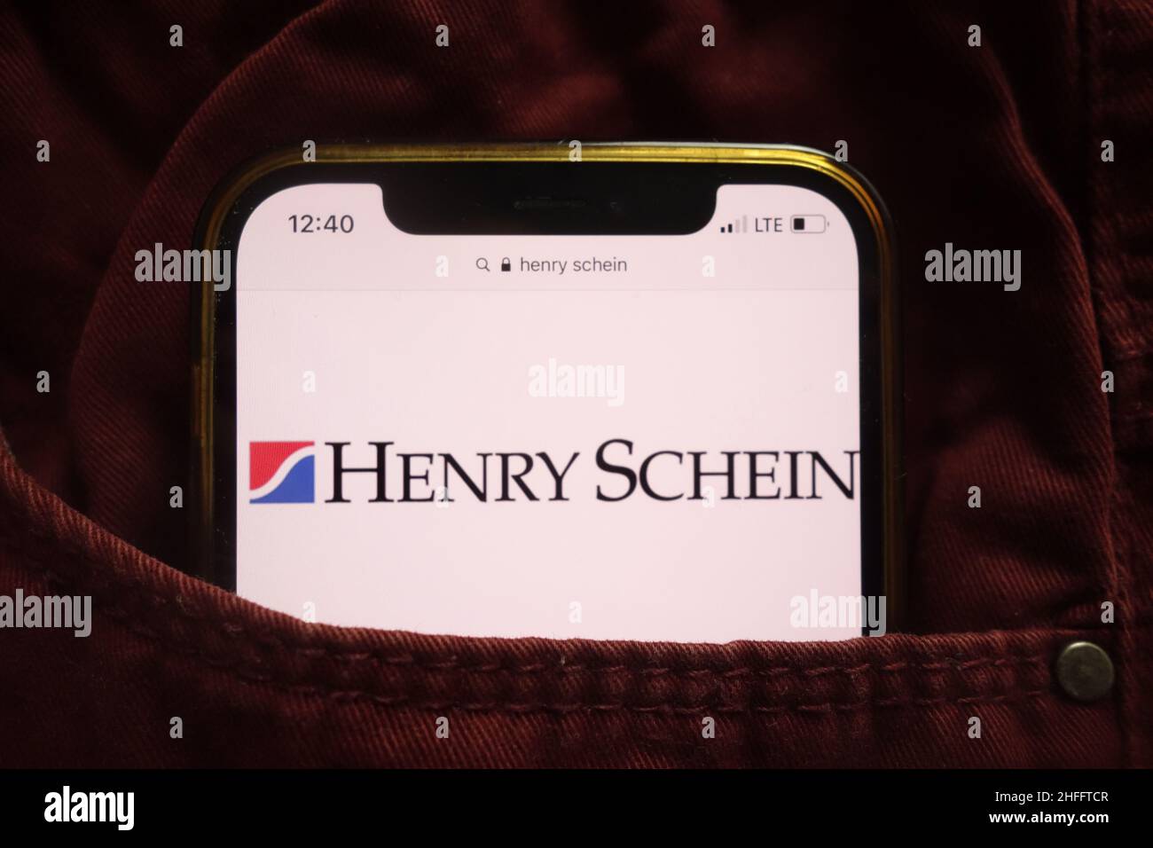 KONSKIE, POLAND - January 15, 2022: Henry Schein Inc logo displayed on mobile phone hidden in jeans pocket Stock Photo
