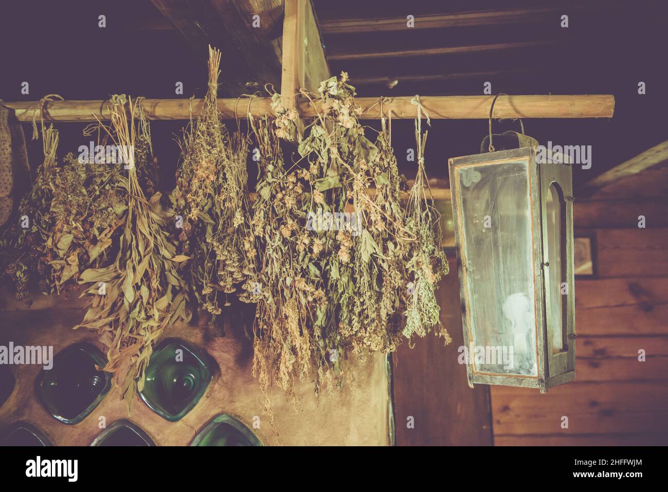 Dry brooms hang in the bath. Dried herbs on very wooden background of