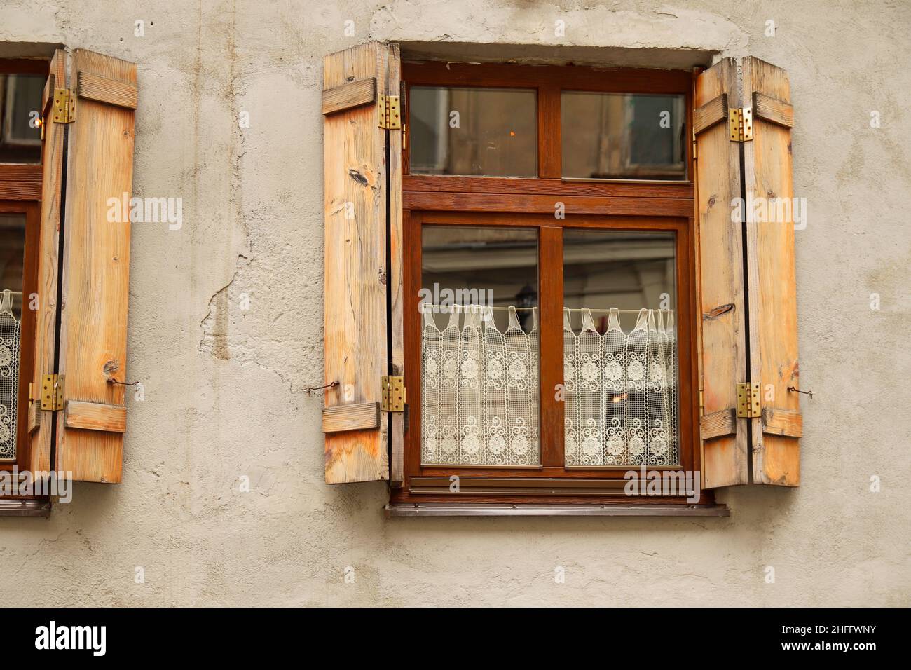 Old window with open wooden shutters. Texture background, window on the wall of a stone house wooden window shutters. Vintage architecture in old city Stock Photo