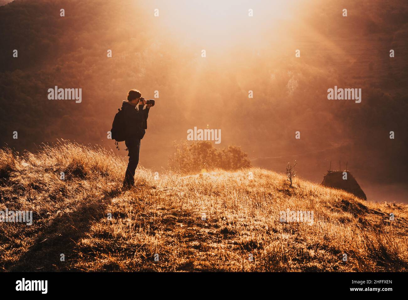 landscape photographer in a beautiful foggy morning sunrise Stock Photo