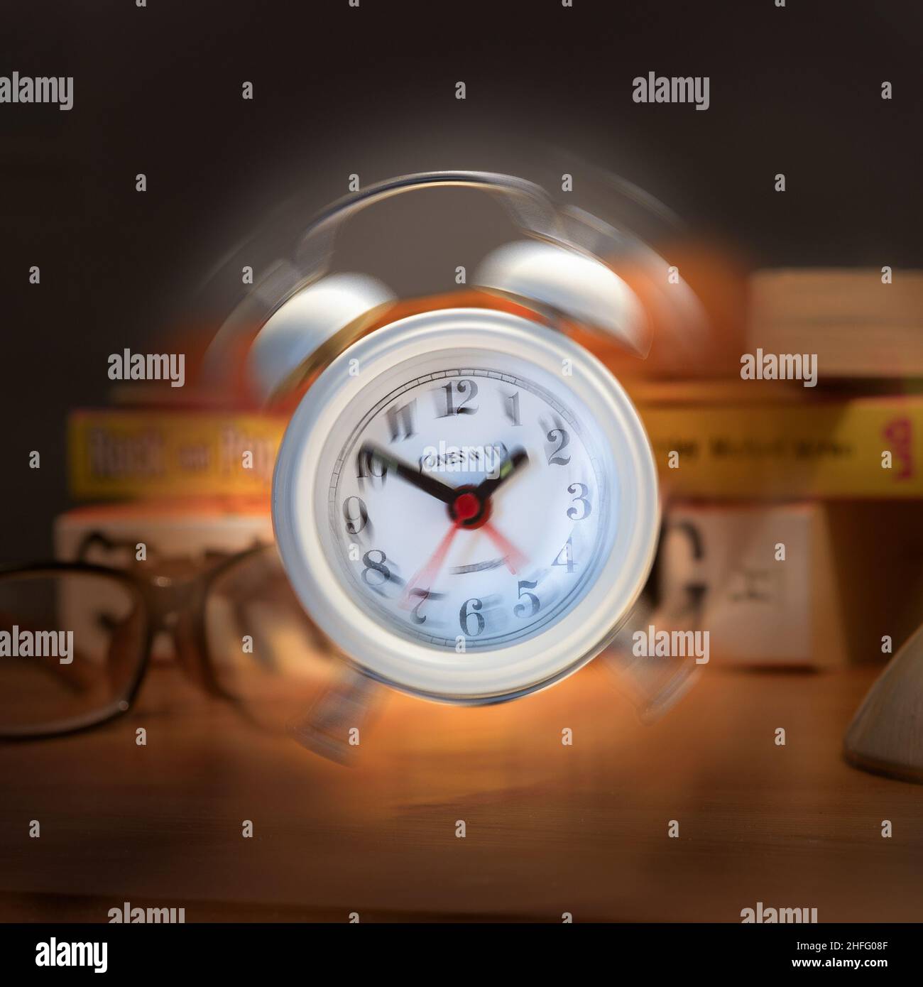 ringing alarm clock on a bedside table Stock Photo