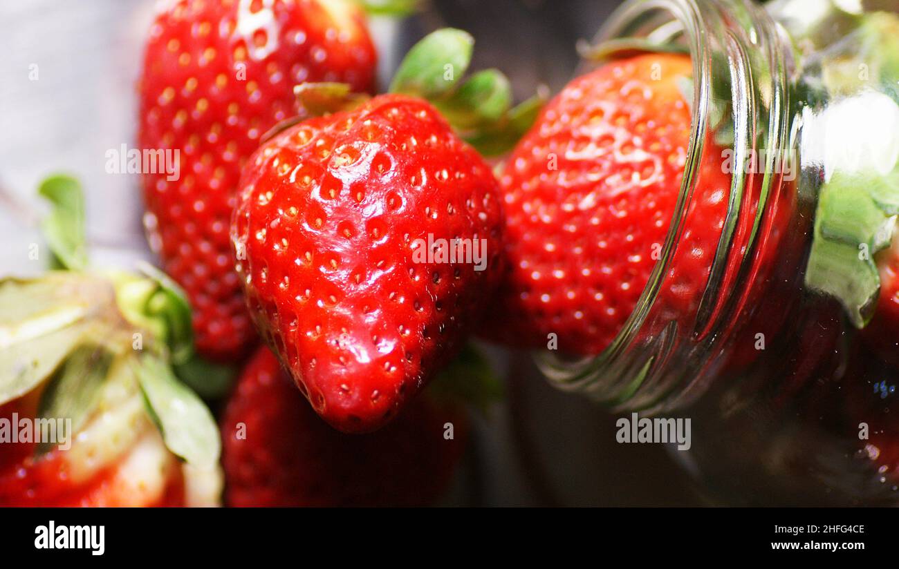 Strawberries in glass jar on white background Stock Photo Alamy